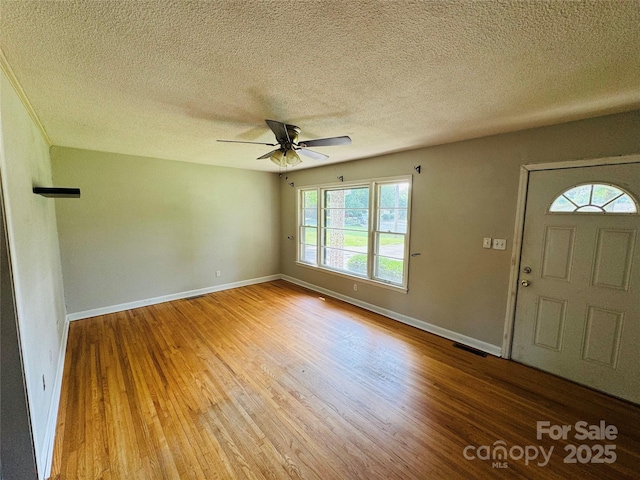 316 Meadowood Cir, Kannapolis, NC 28081 - foyer entrance with wood finished floors, ceiling fan, baseboards, and a textured ceiling