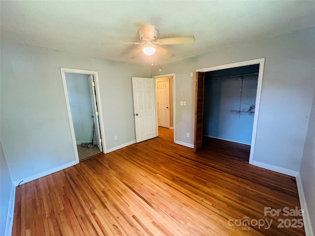 316 Meadowood Cir, Kannapolis, NC 28081 - unfurnished bedroom featuring baseboards, wood finished floors, a closet, and a ceiling fan