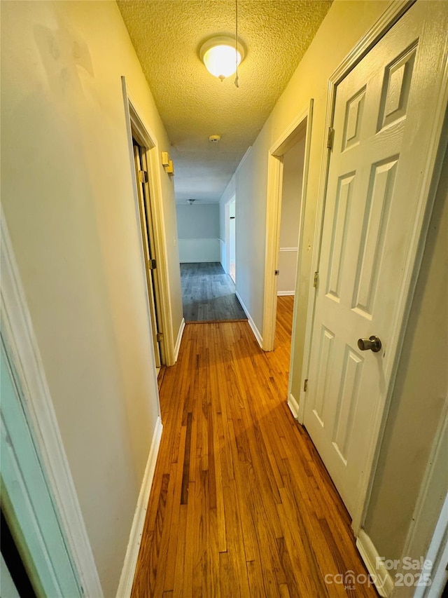 316 Meadowood Cir, Kannapolis, NC 28081 - hallway with dark wood-type flooring, a textured ceiling, and baseboards