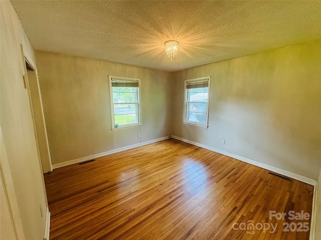 316 Meadowood Cir, Kannapolis, NC 28081 - empty room with wood finished floors, a textured ceiling, and baseboards