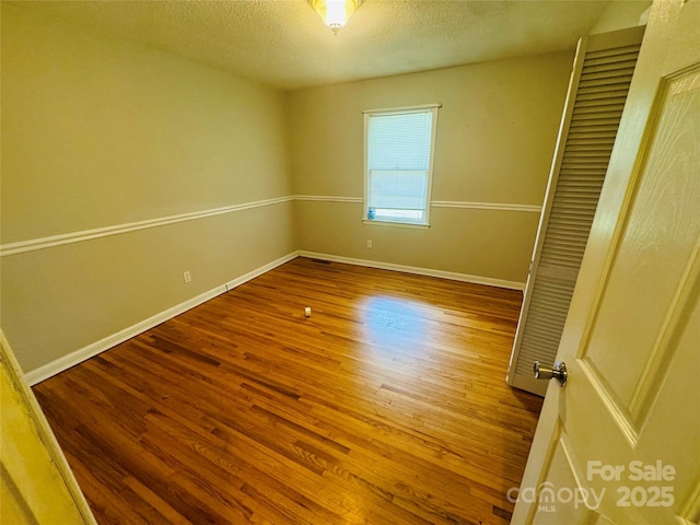 316 Meadowood Cir, Kannapolis, NC 28081 - unfurnished room with wood finished floors, baseboards, and a textured ceiling