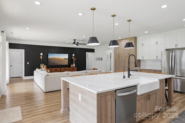 2018 Whiskery Ct, York, SC 29745 - kitchen with appliances with stainless steel finishes, recessed lighting, a ceiling fan, light wood-style floors, and an island with sink