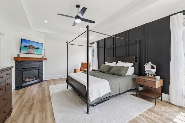 2018 Whiskery Ct, York, SC 29745 - bedroom featuring light wood-style flooring, crown molding, a brick fireplace, a tray ceiling, and recessed lighting