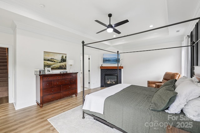 2018 Whiskery Ct, York, SC 29745 - bedroom with wood finished floors, a brick fireplace, a raised ceiling, crown molding, and recessed lighting