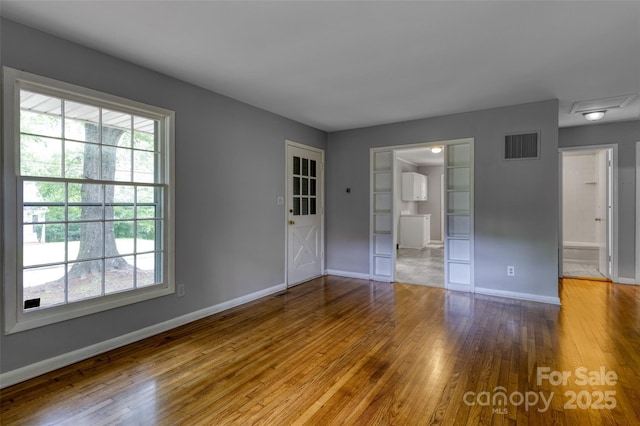 24 19th St NW, Hickory, NC 28601 - unfurnished bedroom with hardwood / wood-style flooring, baseboards, and ensuite bathroom
