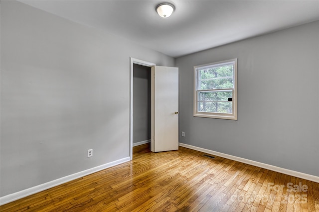 24 19th St NW, Hickory, NC 28601 - unfurnished bedroom featuring baseboards and wood-type flooring