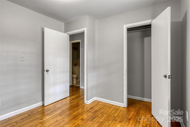 24 19th St NW, Hickory, NC 28601 - unfurnished bedroom featuring a closet, light wood finished floors, and baseboards