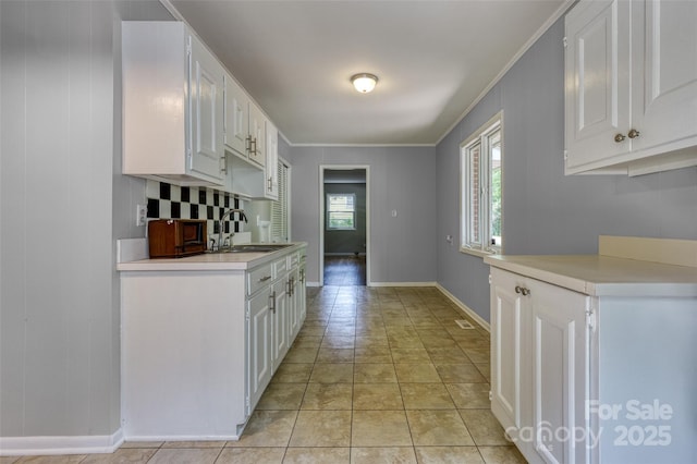 24 19th St NW, Hickory, NC 28601 - kitchen featuring a sink, light countertops, white cabinets, baseboards, and crown molding