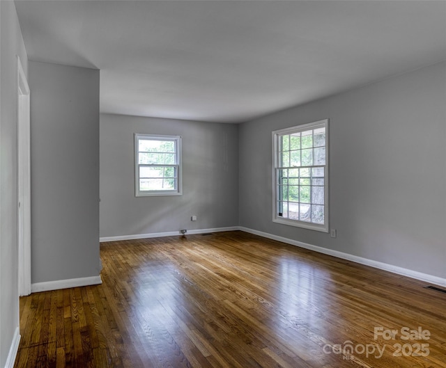 24 19th St NW, Hickory, NC 28601 - empty room with plenty of natural light and wood finished floors