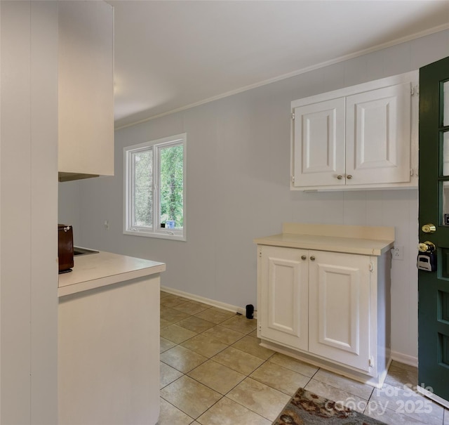 24 19th St NW, Hickory, NC 28601 - kitchen featuring crown molding, light countertops, white cabinetry, and light tile patterned floors
