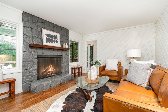1601 Wandering Way Dr, Charlotte, NC 28226 - living area with a stone fireplace, wood finished floors, plenty of natural light, and ornamental molding