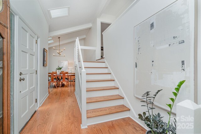1601 Wandering Way Dr, Charlotte, NC 28226 - foyer with ornamental molding, stairway, light wood-style flooring, and a chandelier