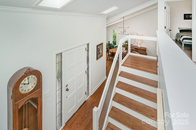 1601 Wandering Way Dr, Charlotte, NC 28226 - staircase with ornamental molding, wood finished floors, and vaulted ceiling