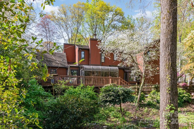 1601 Wandering Way Dr, Charlotte, NC 28226 - rear view of property with a deck, a sunroom, and a chimney