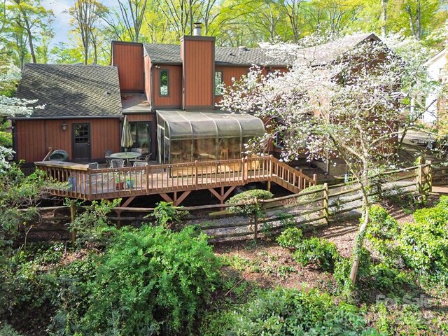 1601 Wandering Way Dr, Charlotte, NC 28226 - rear view of house featuring a sunroom, a shingled roof, a chimney, and a deck