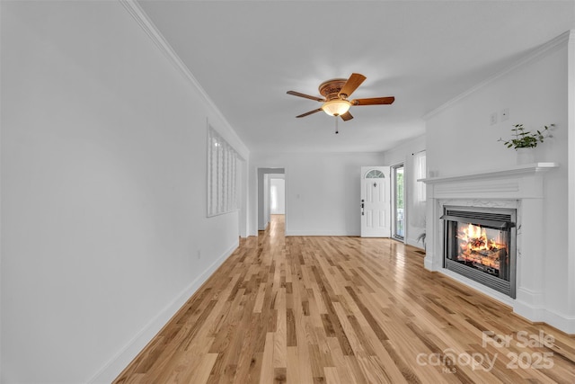 3804 Lippard Ln, Valdese, NC 28690 - unfurnished living room featuring a fireplace, light wood-type flooring, baseboards, a ceiling fan, and crown molding