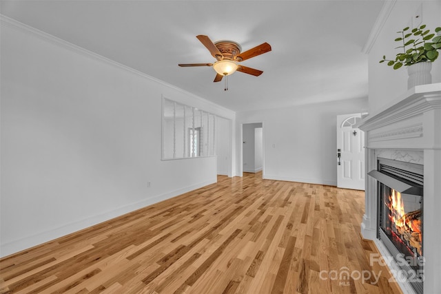 3804 Lippard Ln, Valdese, NC 28690 - unfurnished living room featuring ceiling fan, light wood-type flooring, baseboards, a high end fireplace, and ornamental molding
