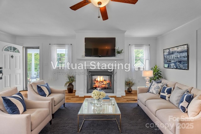 3804 Lippard Ln, Valdese, NC 28690 - living room featuring a ceiling fan, wood finished floors, a lit fireplace, and crown molding