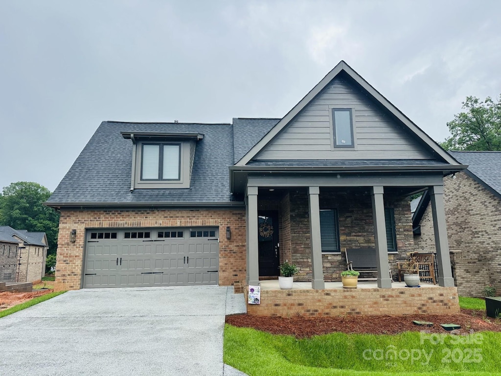 29 Shanklin Ln, Denver, NC 28037 - view of front facade with covered porch, driveway, roof with shingles, and brick siding