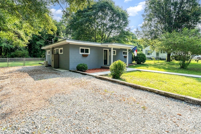 112 Lineberger St, Stanley, NC 28164 - mid-century inspired home featuring driveway, concrete block siding, and view of wooded area