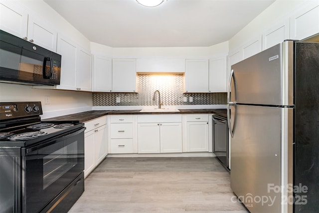 112 Lineberger St, Stanley, NC 28164 - kitchen with black appliances, white cabinetry, light wood-style floors, and backsplash
