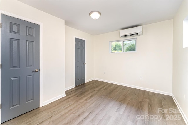 112 Lineberger St, Stanley, NC 28164 - unfurnished bedroom featuring an AC wall unit and wood finished floors