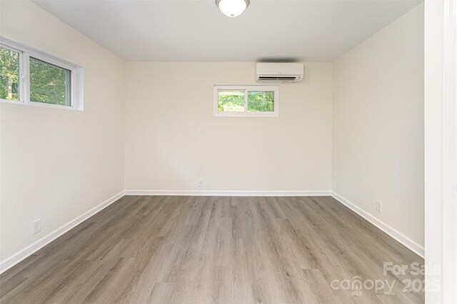 112 Lineberger St, Stanley, NC 28164 - unfurnished room with an AC wall unit and wood finished floors