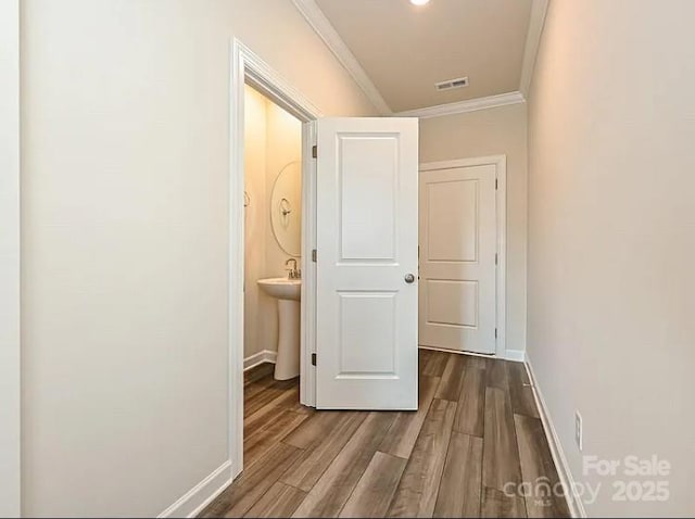 213 Jp Dr, Albemarle, NC 28001 - hall featuring crown molding, dark wood-style flooring, baseboards, and a sink