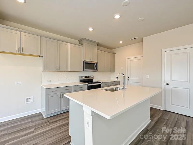 213 Jp Dr, Albemarle, NC 28001 - kitchen featuring stainless steel appliances, a sink, gray cabinetry, dark wood-type flooring, and recessed lighting