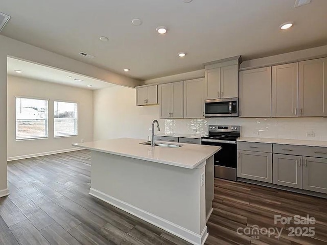 213 Jp Dr, Albemarle, NC 28001 - kitchen with stainless steel appliances, a sink, gray cabinetry, light countertops, and tasteful backsplash
