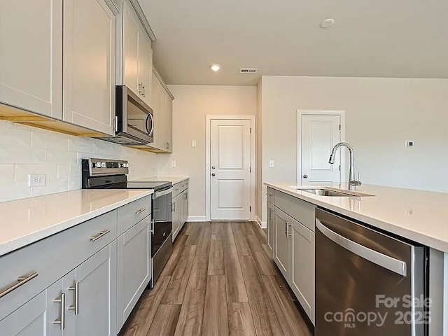 213 Jp Dr, Albemarle, NC 28001 - kitchen with appliances with stainless steel finishes, a sink, gray cabinetry, light countertops, and recessed lighting