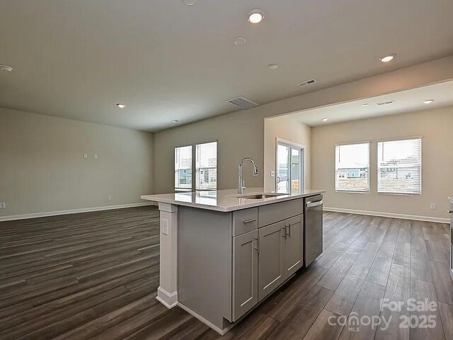 213 Jp Dr, Albemarle, NC 28001 - kitchen with stainless steel dishwasher, a sink, gray cabinets, open floor plan, and dark wood finished floors