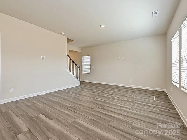 213 Jp Dr, Albemarle, NC 28001 - spare room with stairs, wood finished floors, and baseboards