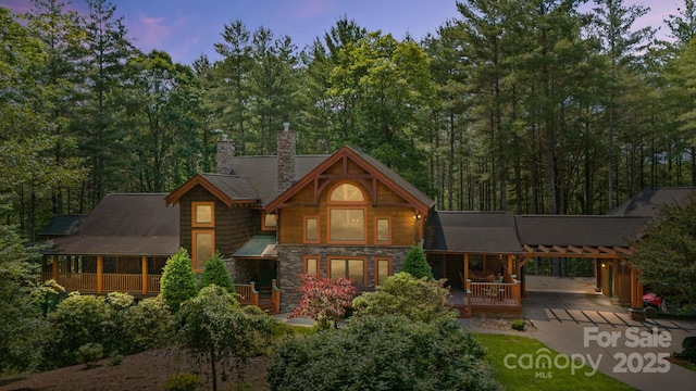5626 Rocky Falls Ln, Lenoir, NC 28645 - view of front facade with a chimney, driveway, a carport, and stone siding