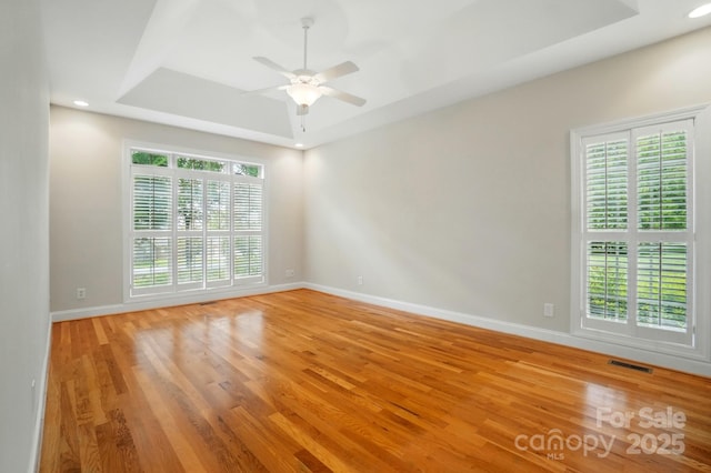 3735 Gordon St, Terrell, NC 28682 - unfurnished room featuring a tray ceiling, light wood-style floors, baseboards, ceiling fan, and recessed lighting