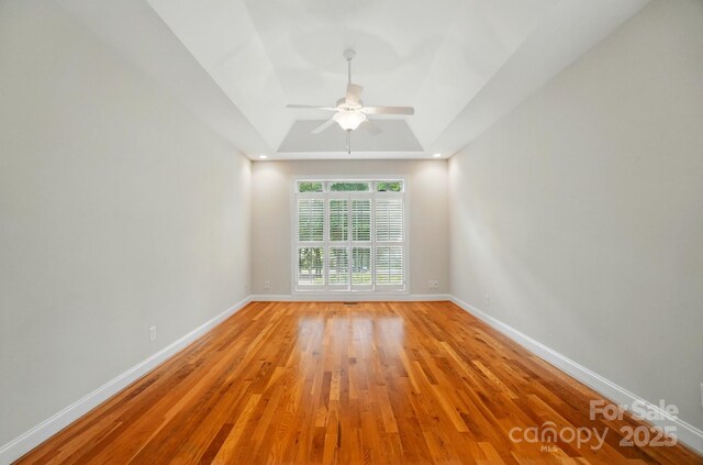 3735 Gordon St, Terrell, NC 28682 - spare room featuring ceiling fan, baseboards, light wood-style flooring, and a tray ceiling