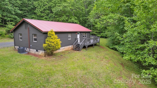 1598 Claybank Rd, West Jefferson, NC 28694 - view of front of home featuring central AC unit, a wooden deck, a front lawn, metal roof, and a view of trees