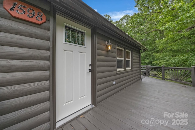 1598 Claybank Rd, West Jefferson, NC 28694 - property entrance featuring faux log siding and a wooden deck