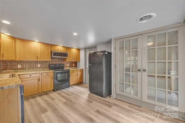 1598 Claybank Rd, West Jefferson, NC 28694 - kitchen featuring black appliances, light wood finished floors, a sink, light countertops, and tasteful backsplash