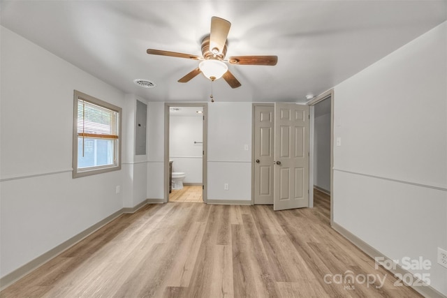 1598 Claybank Rd, West Jefferson, NC 28694 - unfurnished bedroom featuring light wood-type flooring, baseboards, ensuite bathroom, and a ceiling fan