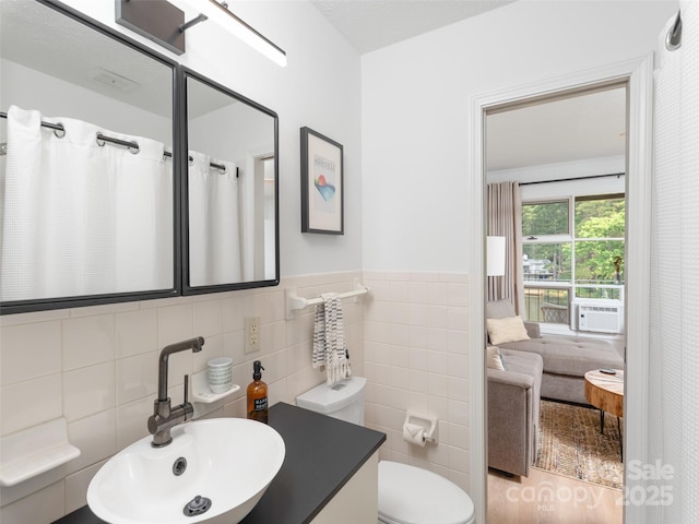 130 Old Mill Rd Unit 222, Flat Rock, NC 28731 - full bath with tile walls, toilet, cooling unit, vanity, and wainscoting