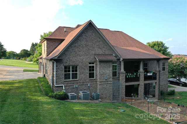 6302 Dwayne Starnes Dr, Hickory, NC 28602 - rear view of house featuring brick siding, cooling unit, and a lawn