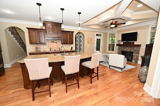 6302 Dwayne Starnes Dr, Hickory, NC 28602 - kitchen with a sink, ornamental molding, a stone fireplace, arched walkways, and coffered ceiling