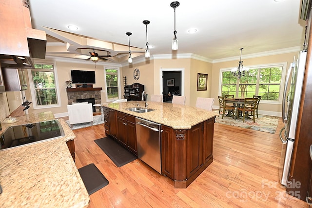 6302 Dwayne Starnes Dr, Hickory, NC 28602 - kitchen featuring appliances with stainless steel finishes, a sink, a ceiling fan, ornamental molding, and a stone fireplace
