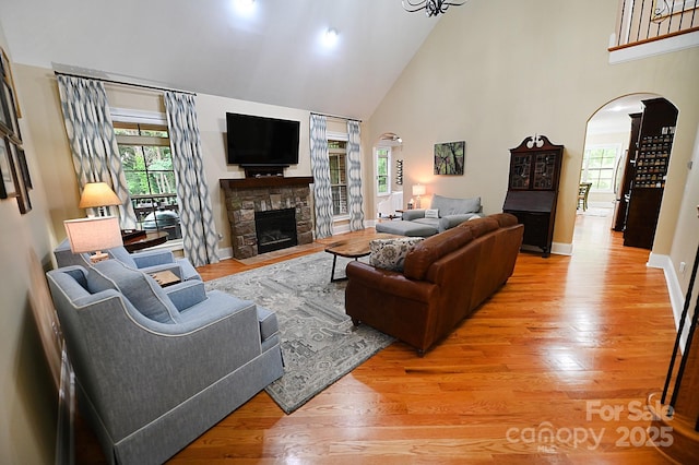 6302 Dwayne Starnes Dr, Hickory, NC 28602 - living area featuring arched walkways, high vaulted ceiling, wood finished floors, and plenty of natural light