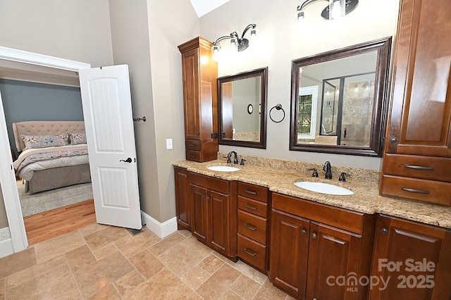 6302 Dwayne Starnes Dr, Hickory, NC 28602 - ensuite bathroom featuring double vanity, baseboards, and stone finish floors