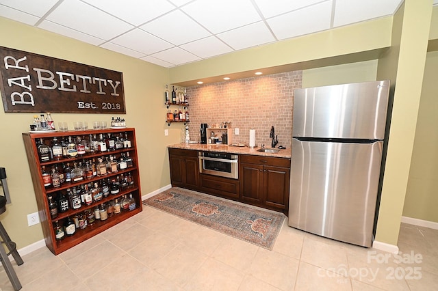 6302 Dwayne Starnes Dr, Hickory, NC 28602 - indoor wet bar with stainless steel appliances, a drop ceiling, light tile patterned flooring, and baseboards