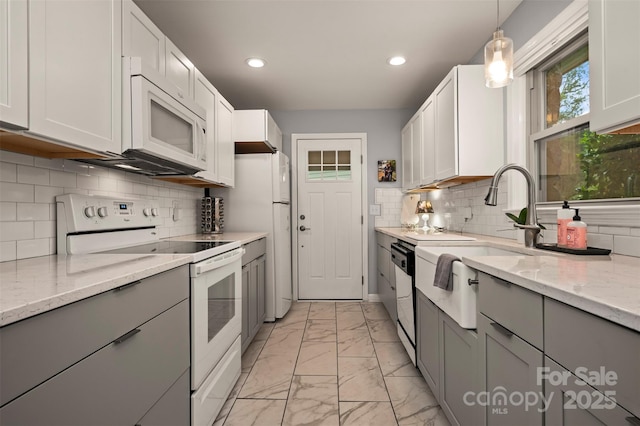 44 Jervey Rd Unit 3A, Tryon, NC 28782 - kitchen featuring white appliances, gray cabinets, light marble finish floors, a sink, and recessed lighting