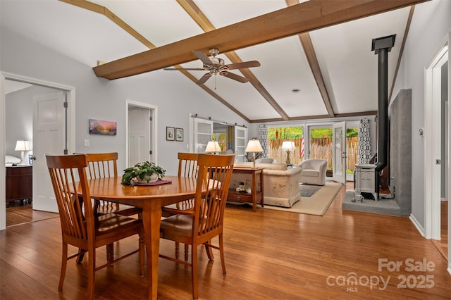 44 Jervey Rd Unit 3A, Tryon, NC 28782 - dining area featuring a wood stove, ceiling fan, and light wood finished floors