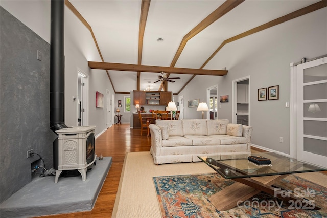 44 Jervey Rd Unit 3A, Tryon, NC 28782 - living room featuring a wood stove, light wood-style floors, ceiling fan, and baseboards
